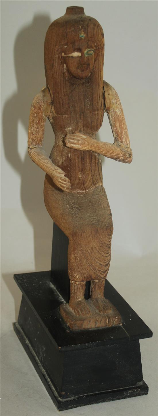 A carved wood figure of a seated ancient Egyptian woman, 12in.